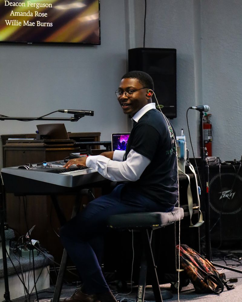 Musician smiling at the keyboard during worship